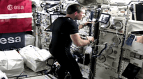 astronaut controlling robot
