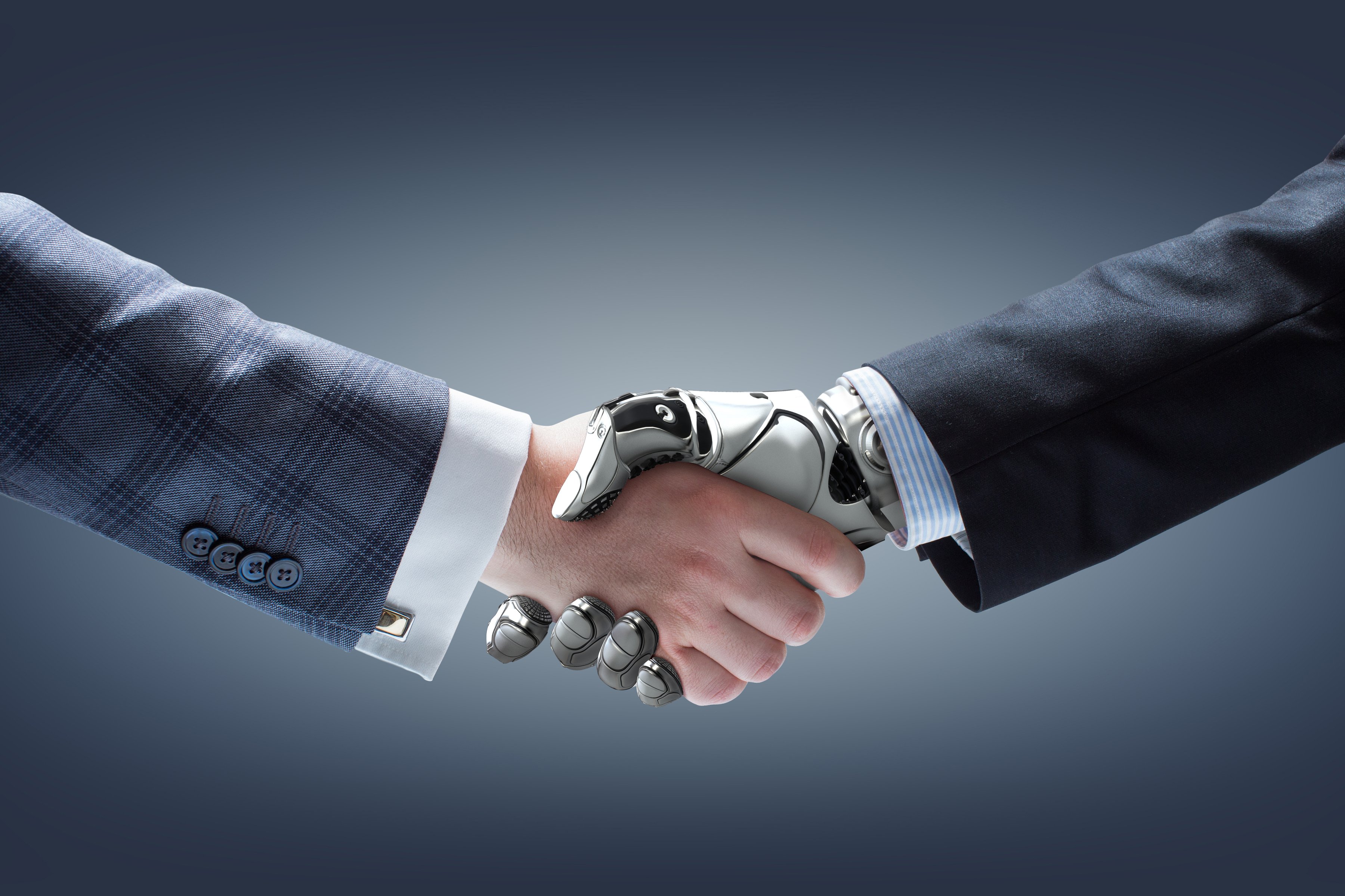 human and robot shaking hands