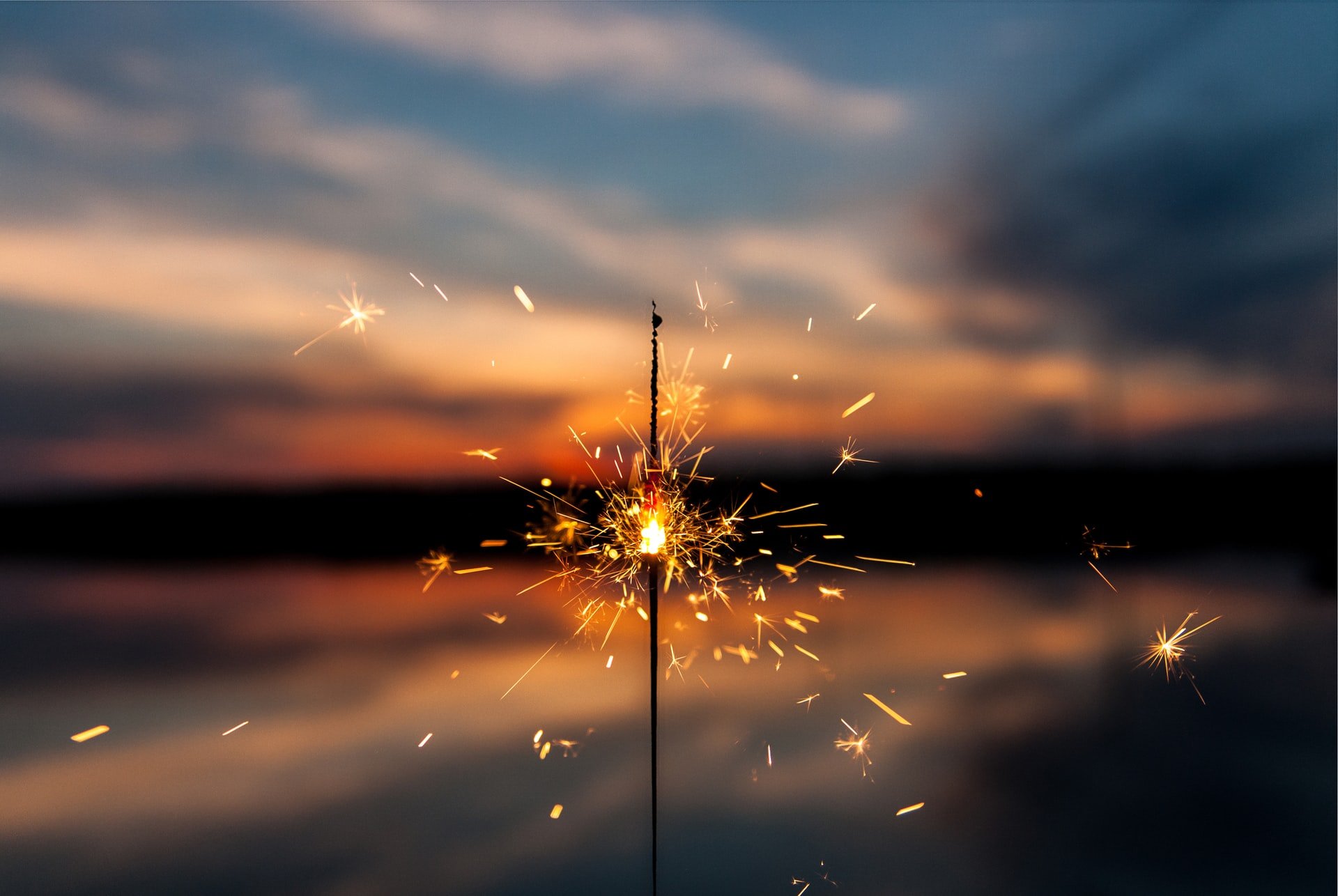 person holding a lit sparkler